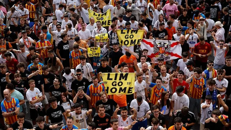Valencia fans protest against management and players following a heavy defeat to Barcelona.